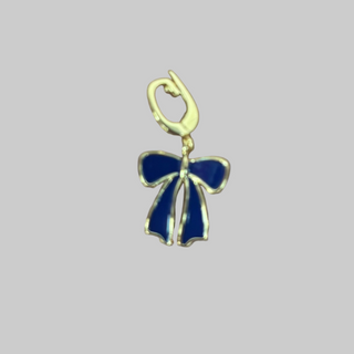Gold charm with a blue bow on a gray background